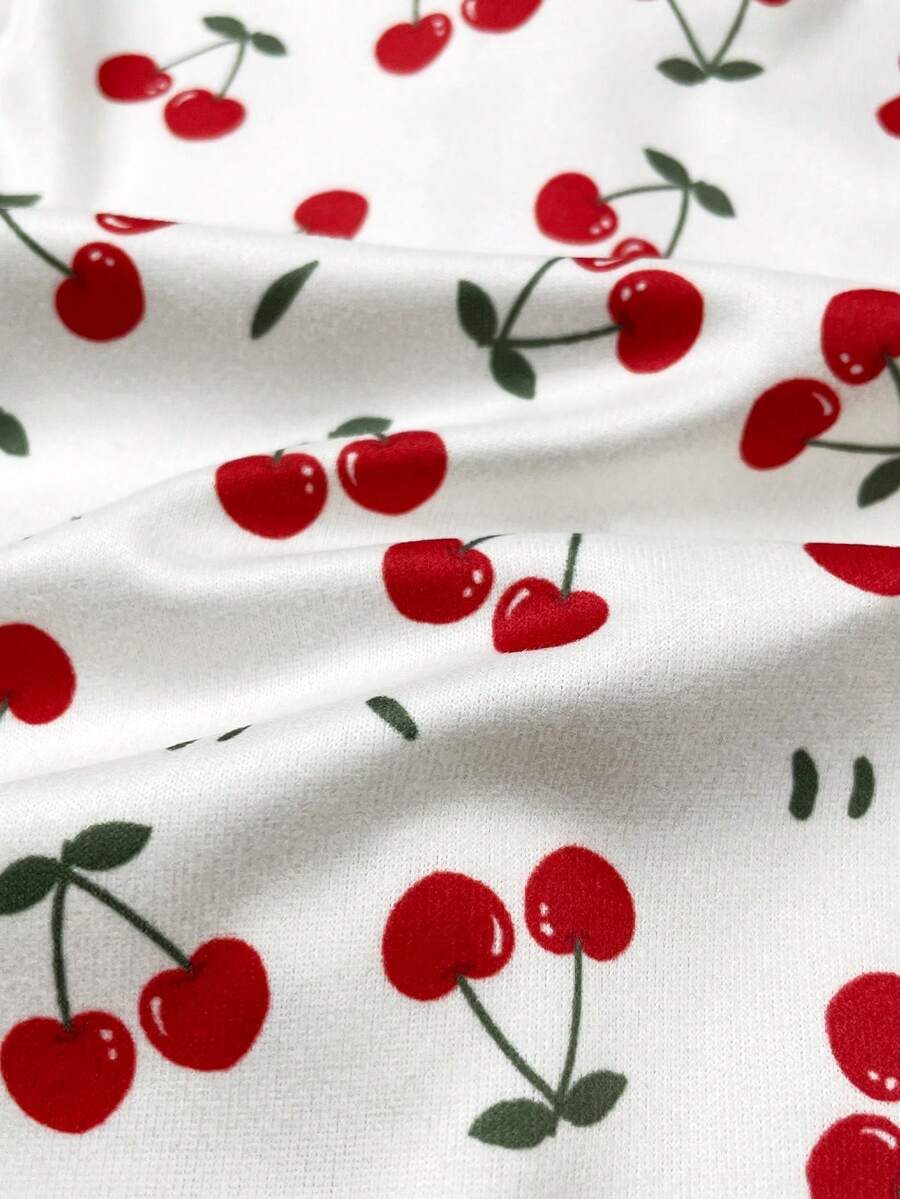 Macacão com pezinhos e zíper para bebê · Cerejas branco 