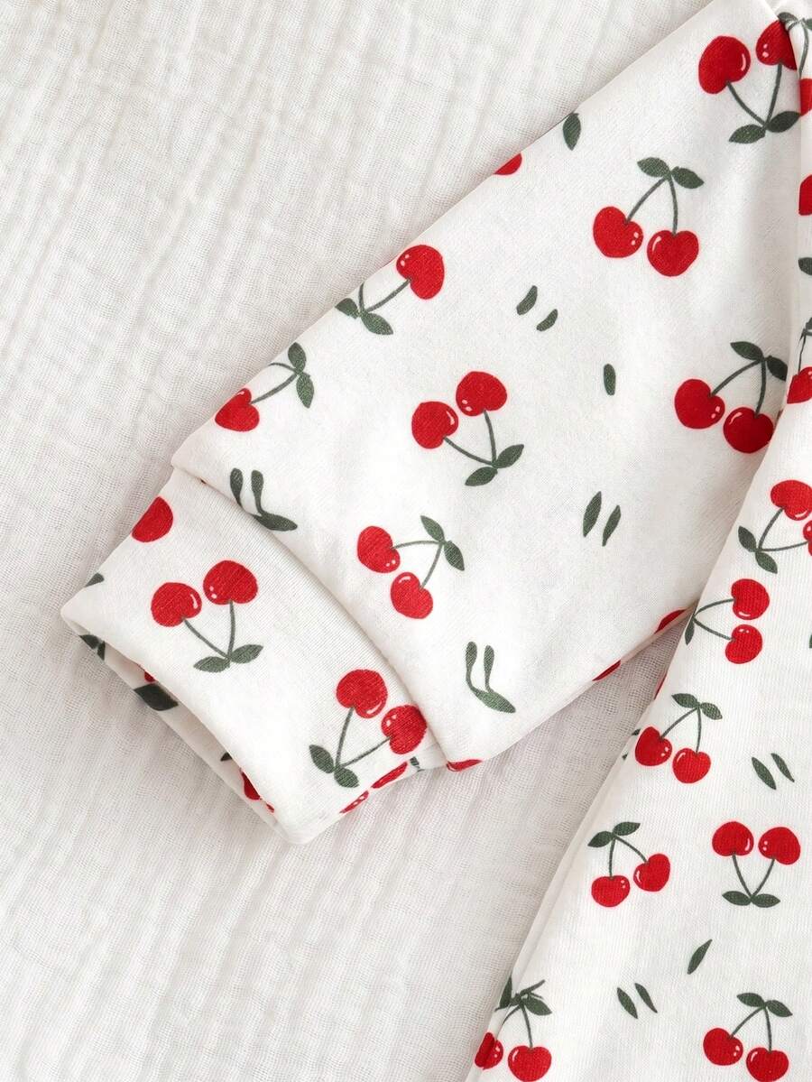 Macacão com pezinhos e zíper para bebê · Cerejas branco 